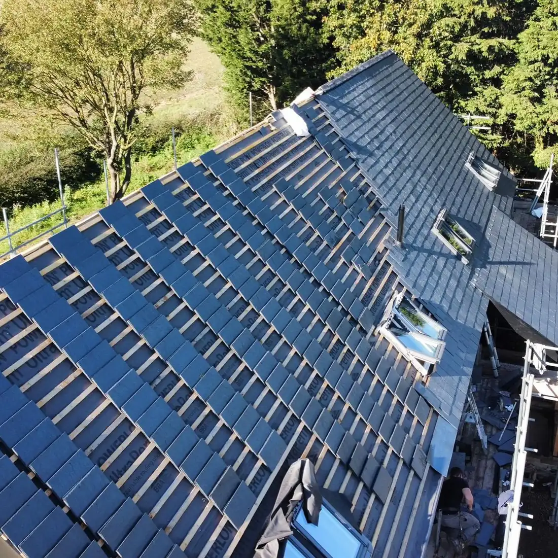 Dark slate roof with skylights on a large detached home in Essex