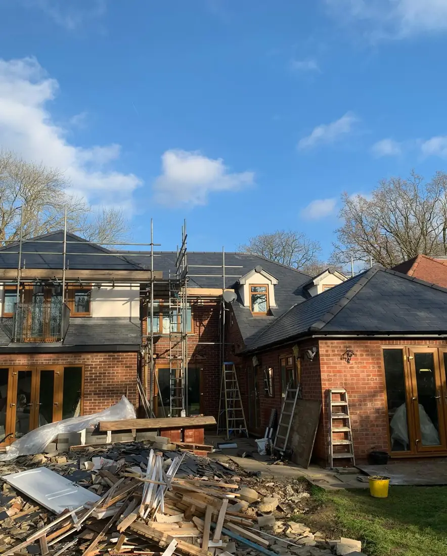 Scaffolded detached house with a new slate roof in Hertfordshire