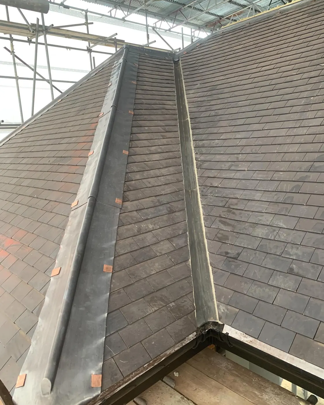 Natural slate roof valley with lead gutter
