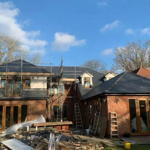 Scaffolded detached house with a new slate roof in Hertfordshire