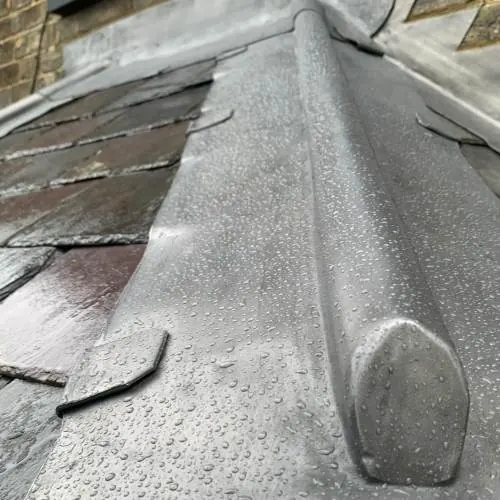 Lead-covered hip on a tiled roof with a decorative lead end