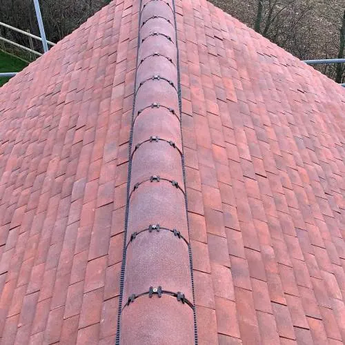 Red clay tile roof with a ridge tile detail