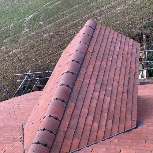 Red clay tile hip on a period property roof
