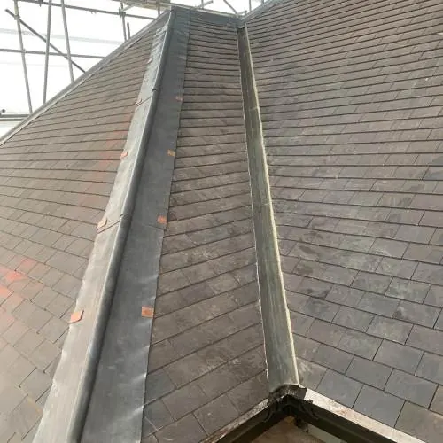 Natural slate roof valley with lead gutter