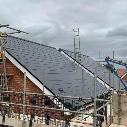 New slate roof on a brick house with scaffolding in Essex
