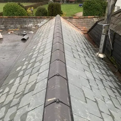 Slate roof ridge and hips on a detached house