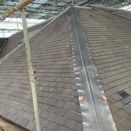 Slate roof valley with lead flashing under construction