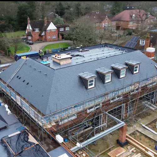New slate roof with dormer windows on a large residential building