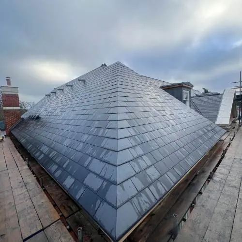 Freshly laid slate hipped roof on a home in Essex